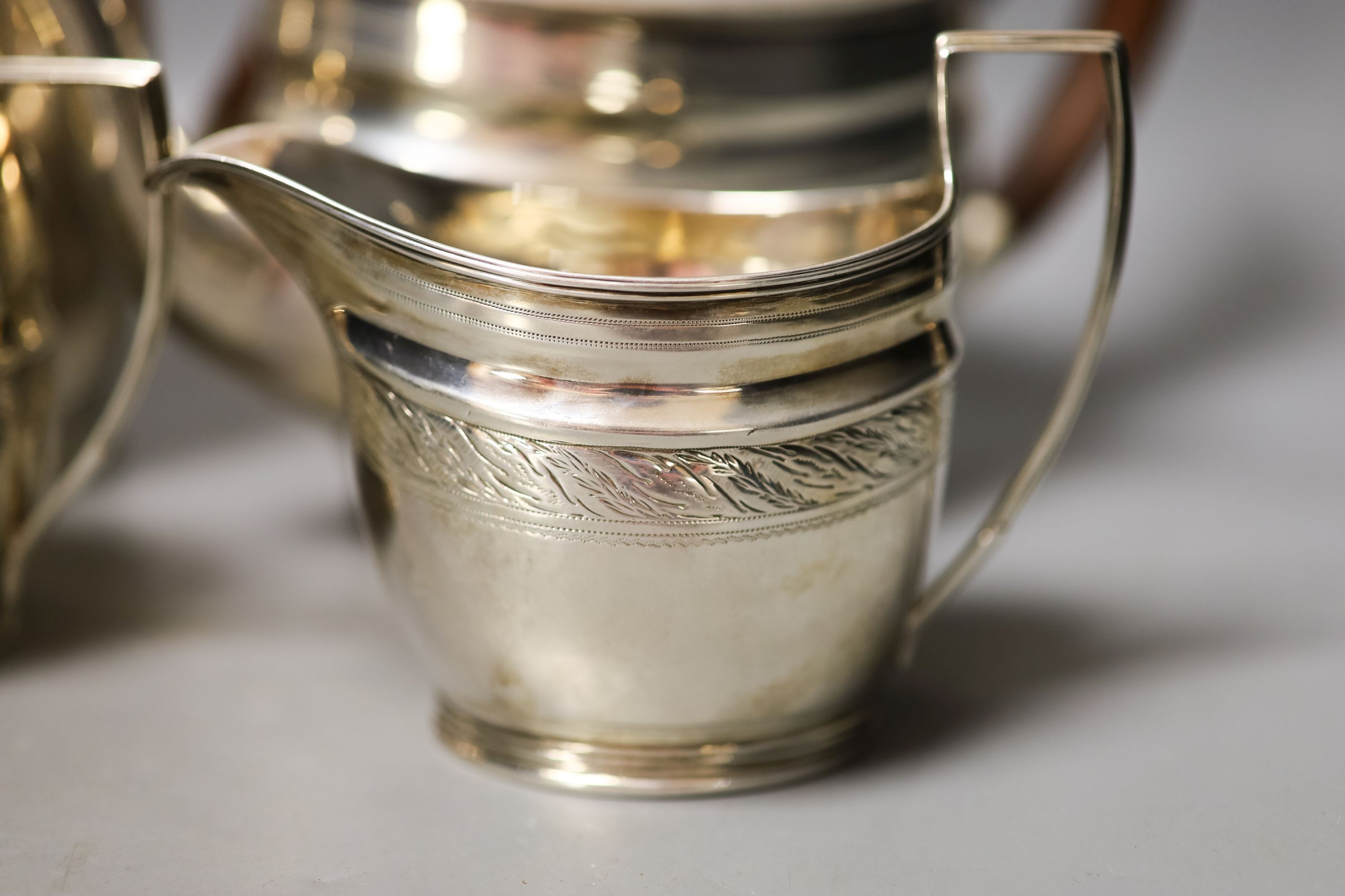 A George V three piece silver oval tea set, London, 1930, together with a similar George III silver cream jug, London, 1800